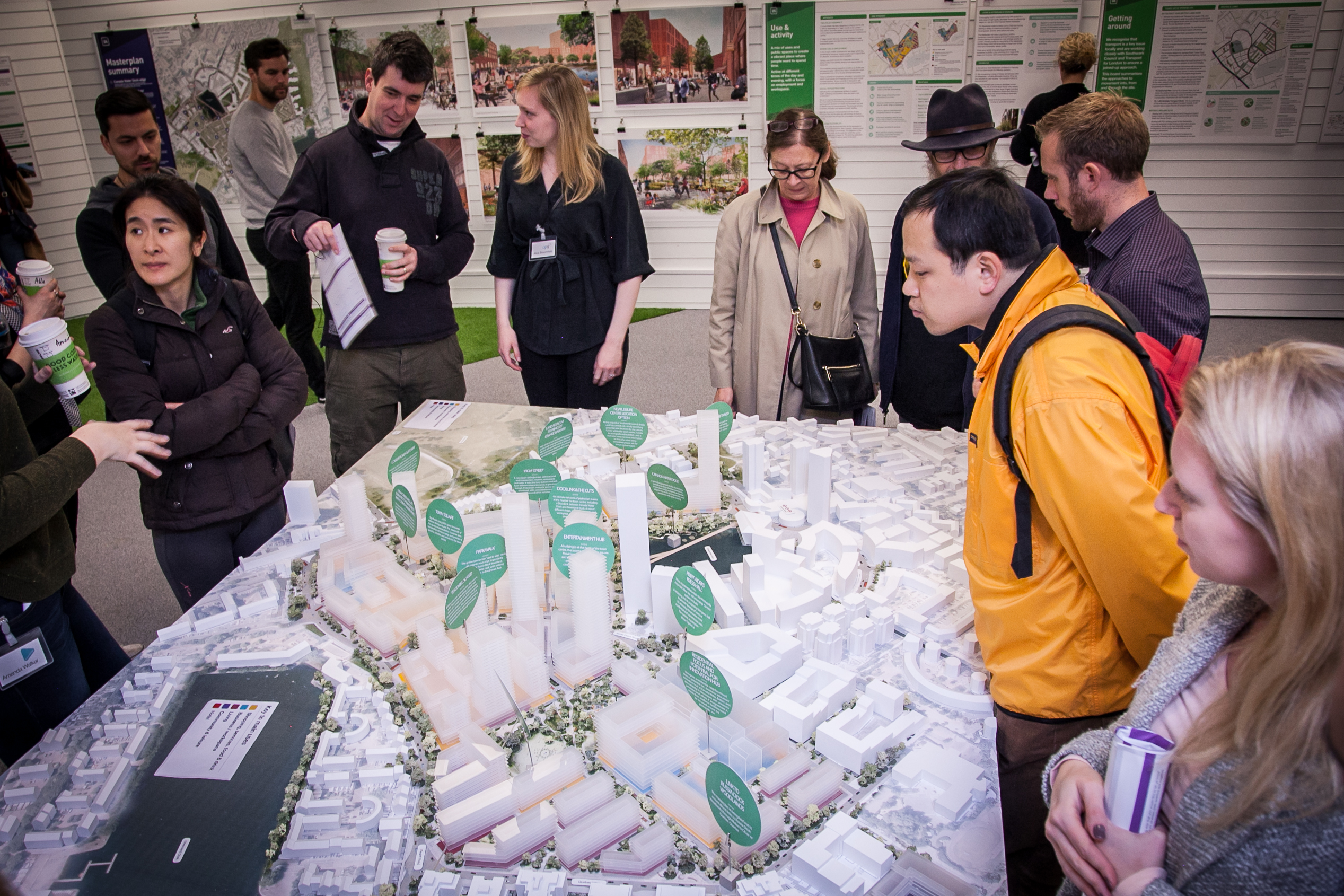People inspecting a model of the proposed development at a community consultation exercise